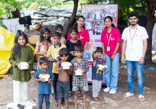 Spreading Bliss Foundation team distributing food to underprivileged children during their weekly food drive, bringing direct support to vulnerable families in need.
