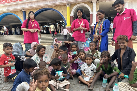 Spreading Bliss Foundation volunteers distributing food to underprivileged children.