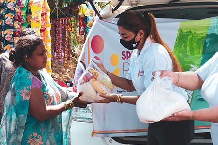 Spreading Bliss volunteer donating ration kits 
 
        