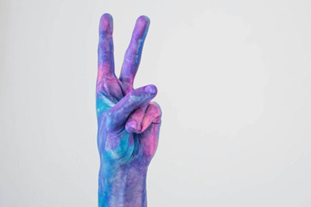A painted  hand representing peace
 
        