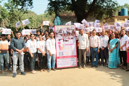 Team members of Spreading Bliss Foundation gathered in a group photo with a banner and placards.